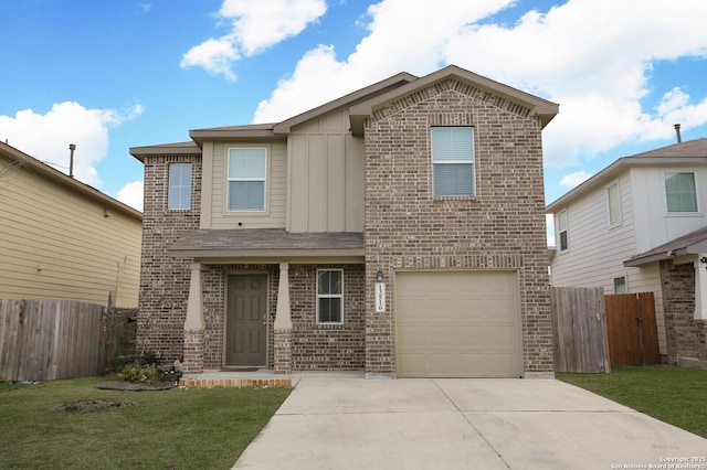 view of property featuring a front lawn and a garage