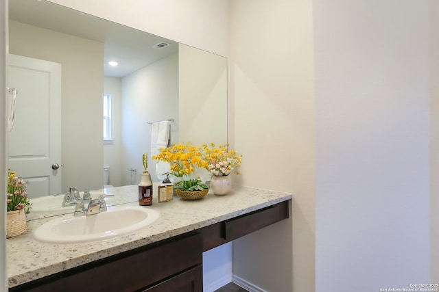 bathroom with vanity and toilet