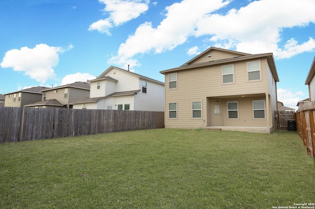 rear view of property with a yard