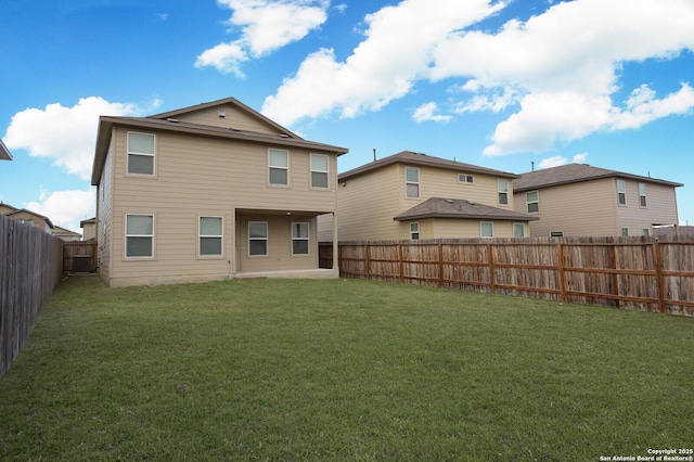 rear view of property featuring a yard