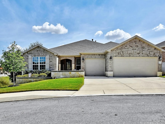 view of front facade featuring a front yard and a garage