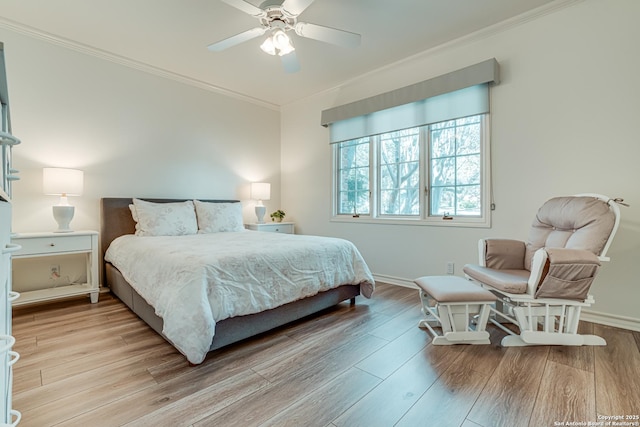 bedroom featuring light hardwood / wood-style flooring, ceiling fan, and crown molding