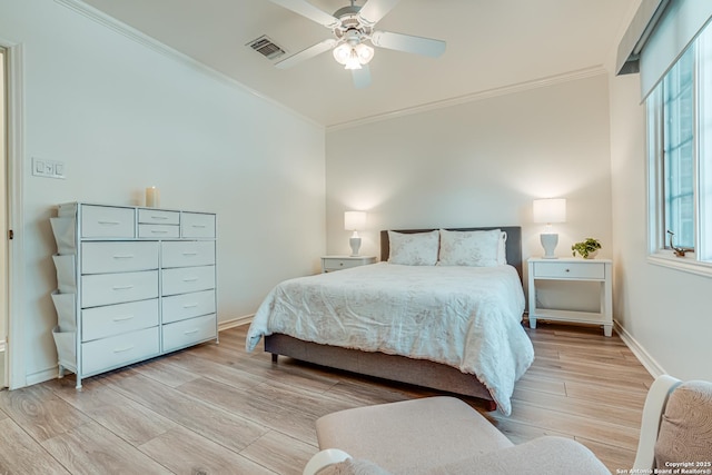 bedroom with light wood-type flooring, ceiling fan, and ornamental molding