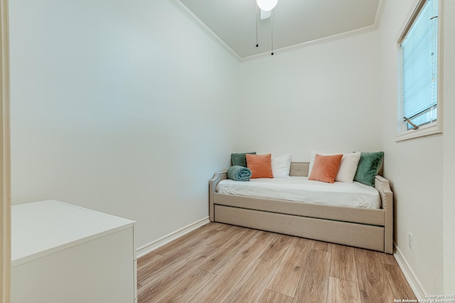 bedroom with ceiling fan, light hardwood / wood-style floors, and crown molding