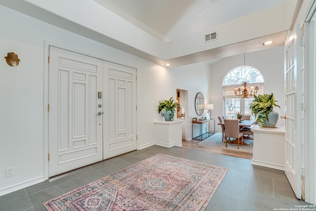 entrance foyer featuring an inviting chandelier