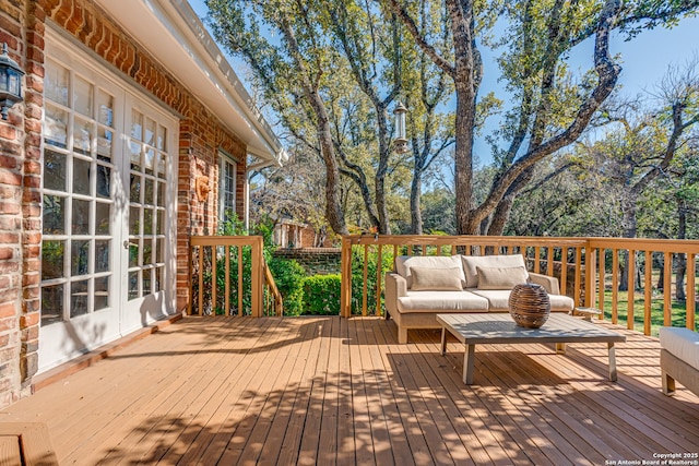 wooden terrace featuring french doors and an outdoor hangout area