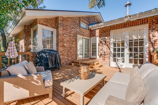 wooden deck with area for grilling, an outdoor hangout area, and french doors