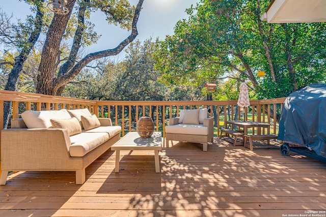 deck featuring outdoor lounge area and grilling area