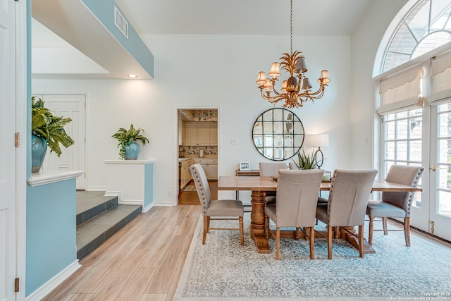 dining area featuring a chandelier and light hardwood / wood-style floors