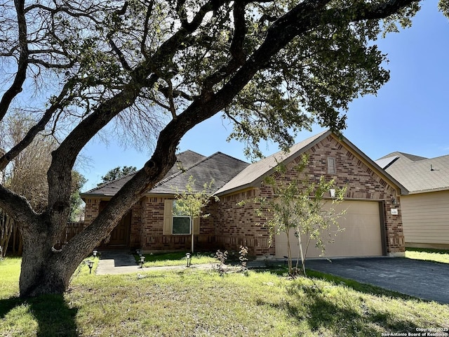 view of front of property with a garage and a front yard