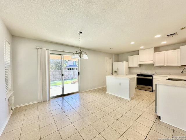 kitchen with electric stove, white fridge with ice dispenser, a center island, white cabinetry, and hanging light fixtures