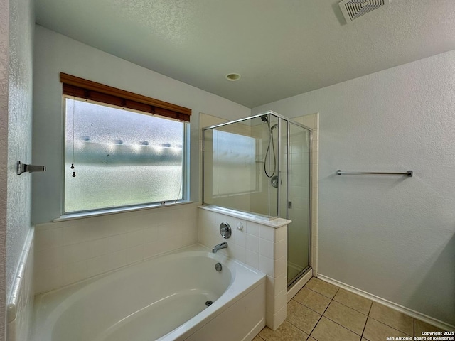 bathroom with tile patterned floors and independent shower and bath