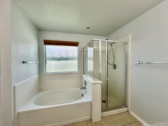 bathroom featuring tile patterned flooring, a textured ceiling, and shower with separate bathtub