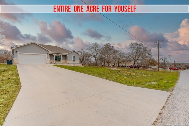 view of front facade with a garage and a front lawn