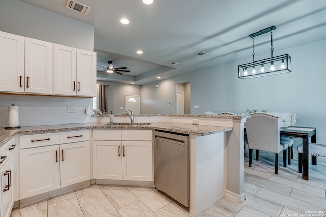 kitchen with kitchen peninsula, sink, and white cabinets