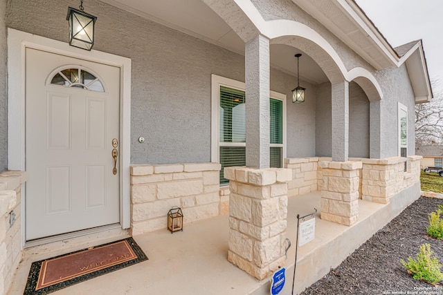 view of exterior entry with a porch