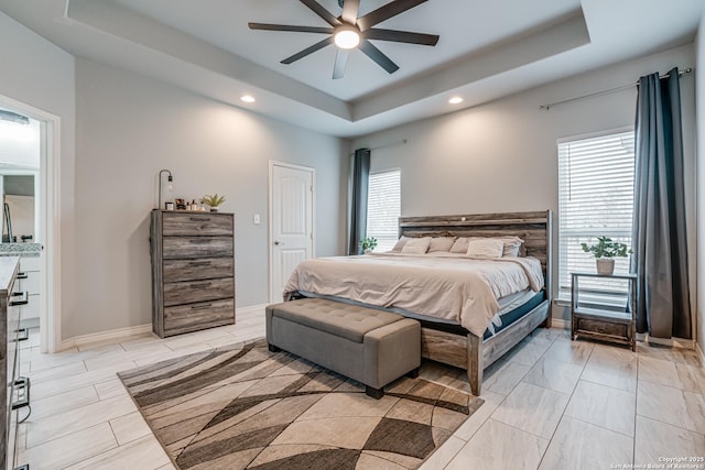 bedroom with a tray ceiling and ceiling fan