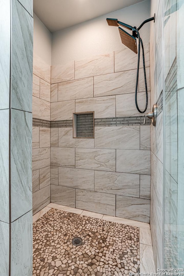 bathroom with tiled shower