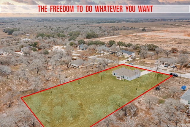 aerial view at dusk featuring a rural view