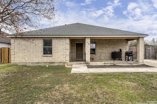 rear view of house featuring a patio and a lawn