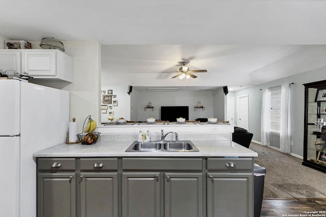 kitchen with dark carpet, white refrigerator, sink, ceiling fan, and gray cabinets