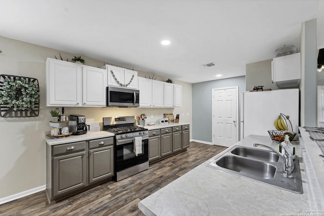 kitchen with stainless steel appliances, white cabinetry, gray cabinetry, and sink