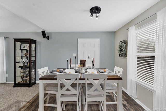 dining space with dark colored carpet