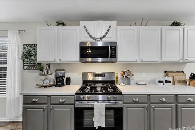 kitchen with gray cabinets, white cabinets, and stainless steel appliances