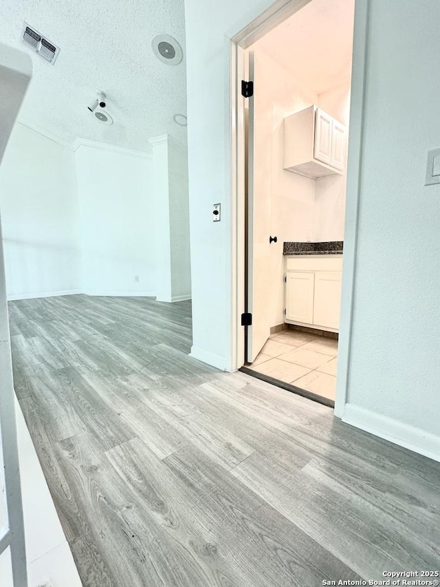 interior space featuring light hardwood / wood-style floors and a textured ceiling