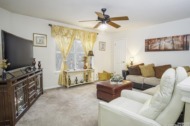 living room with a textured ceiling, light colored carpet, and ceiling fan