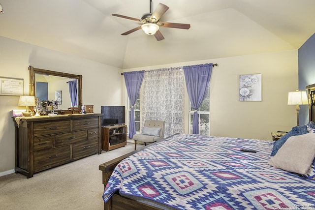 carpeted bedroom with ceiling fan and vaulted ceiling