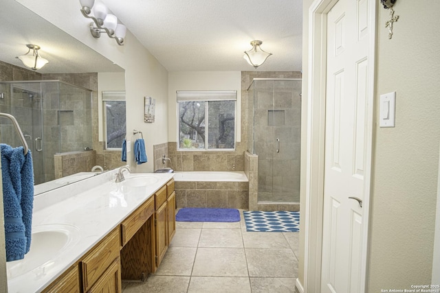 bathroom featuring tile patterned flooring, vanity, independent shower and bath, and a textured ceiling