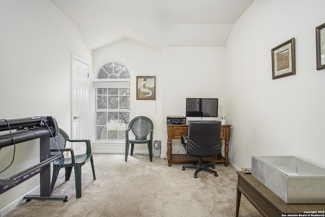 carpeted office space featuring vaulted ceiling