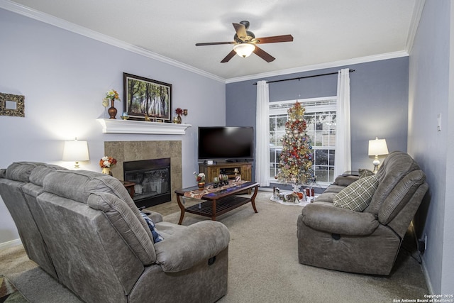 carpeted living room featuring ceiling fan, ornamental molding, and a fireplace