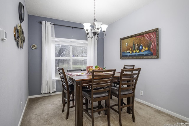 carpeted dining room featuring a notable chandelier