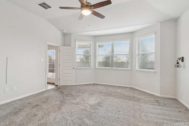 carpeted empty room featuring ceiling fan and lofted ceiling