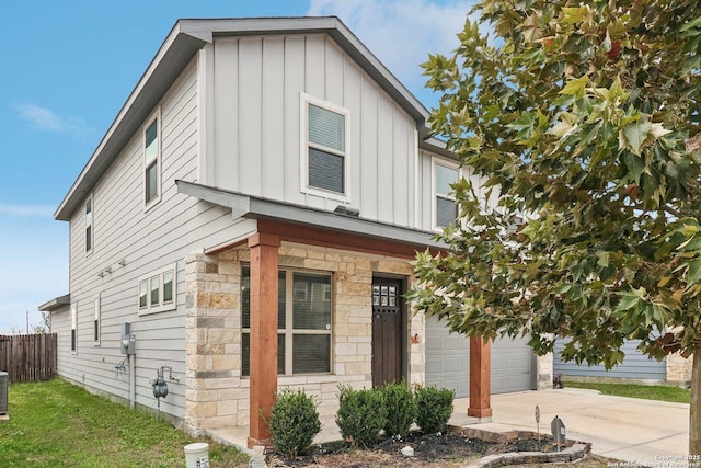 view of front facade featuring central AC unit and a garage