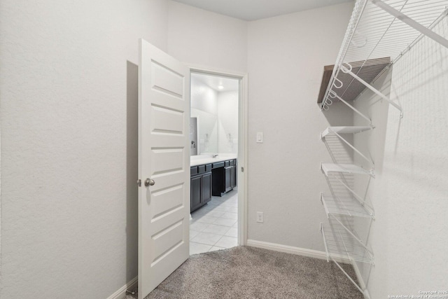 walk in closet featuring light carpet