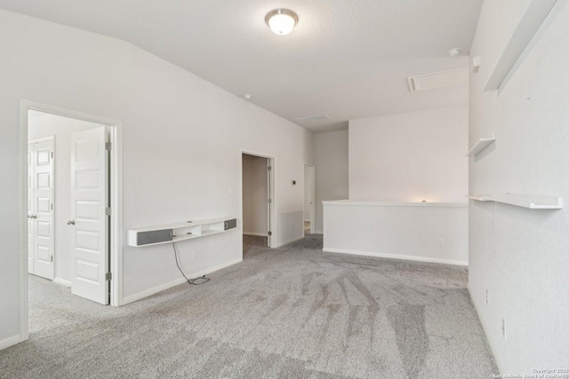 interior space with carpet flooring and vaulted ceiling