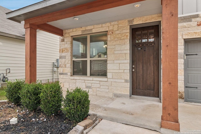 view of exterior entry with a porch