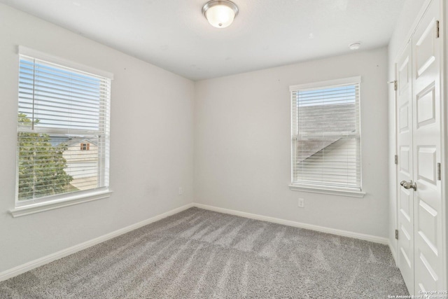 unfurnished room with light carpet