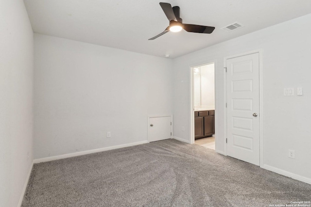 spare room featuring ceiling fan and light colored carpet