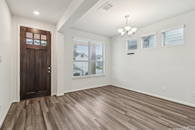 entryway featuring dark hardwood / wood-style floors and an inviting chandelier