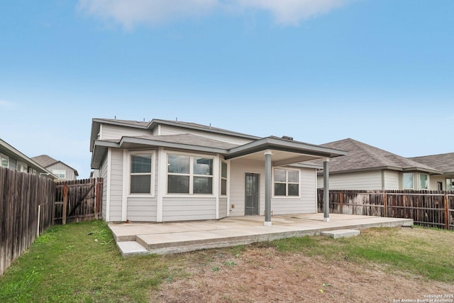 rear view of house featuring a patio area and a lawn