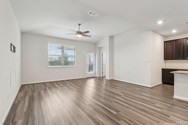 unfurnished living room with ceiling fan, hardwood / wood-style floors, and lofted ceiling