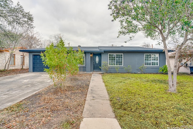 view of front of property with a garage and a front lawn