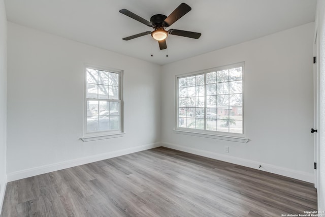 empty room featuring ceiling fan and hardwood / wood-style floors