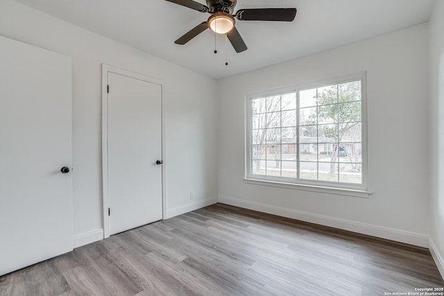 spare room featuring ceiling fan and light wood-type flooring