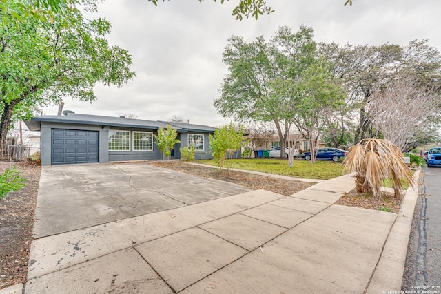 single story home featuring a garage and a front yard