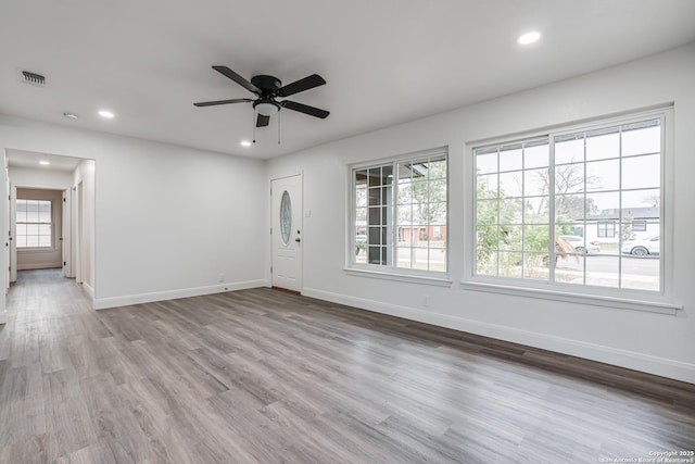 unfurnished room featuring ceiling fan and light wood-type flooring